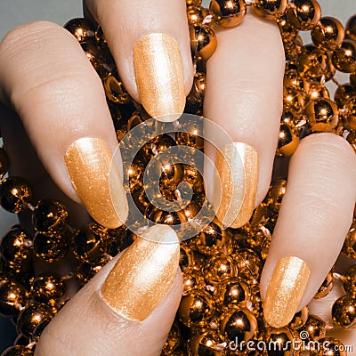 Glossy golden nails Stock Photo