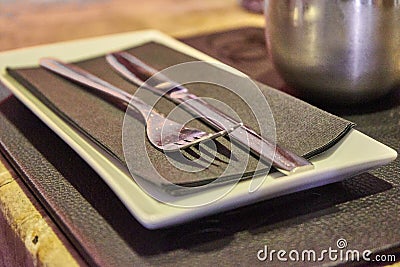 Glossy Metal Fork And Knive On a Black Napkin Stock Photo