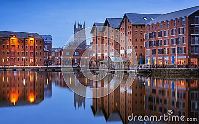 Gloucester docks and Cathedral reflected in the quay on Sharpness at twilight Stock Photo