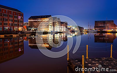 Gloucester docks on sharpness canal. Warehouse apartments reflected in quay water Stock Photo