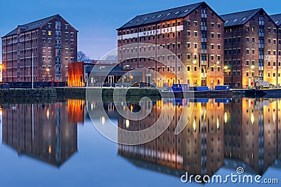 Gloucester docks warehouses reflected in quay on Sharpness Canal Stock Photo