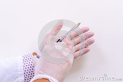 Gloved doctor hands holding an injection vial of a hyaluronic acid HA based dermal filler for anti-aging and volumizing face tre Stock Photo