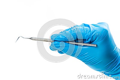 Gloved hand with dental instrument Stock Photo