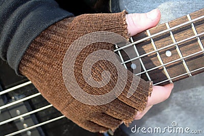 Gloved Hand on Frets Stock Photo