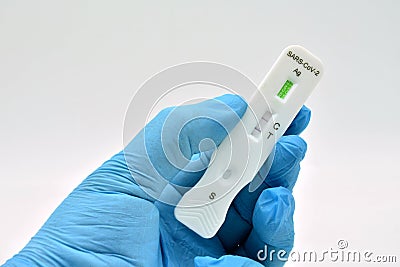 Gloved hand holding an antigen test Stock Photo