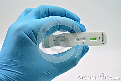 Gloved hand holding an antigen test Stock Photo