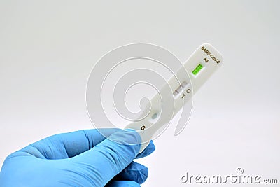 Gloved hand holding an antigen test Stock Photo