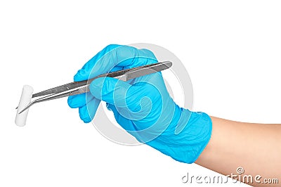 Gloved hand holding a pair of tweezers with a cotton swab on the Stock Photo