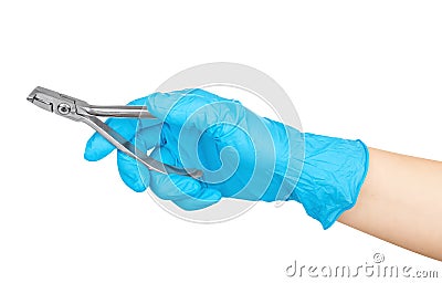 Gloved hand holding a pliers to remove teeth Stock Photo