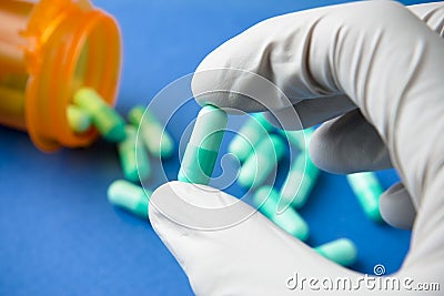 Gloved Hand Holding Prescription Pill Stock Photo