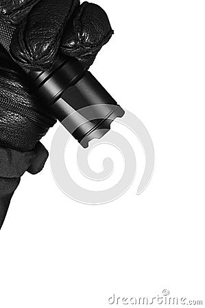 Gloved Hand Holding Tactical Flashlight, Bright Light Emiting Brightly Lit, Serrated Strike Bezel, Black Grain Leather Glove Stock Photo