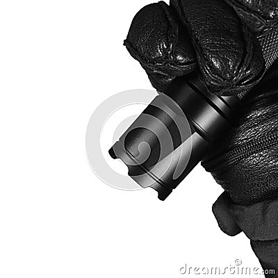 Gloved Hand Holding Tactical Flashlight, Bright Light Emiting Brightly Lit, Serrated Strike Bezel, Black Grain Leather Glove Stock Photo