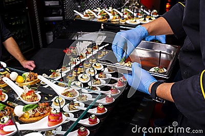 Gloved hands putting food Stock Photo