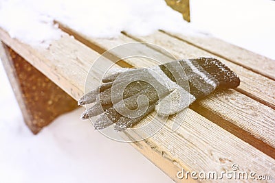 gloves on a wooden bench on a cold winter day Stock Photo