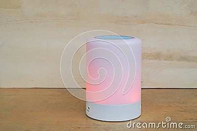 Glow speaker in light red color and modern wireless speaker for listening to music by bluetooth Stock Photo