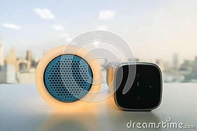 Glow speaker in orange color and modern wireless speaker for listening to music Stock Photo