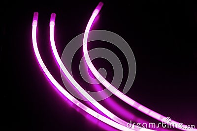 Glow sticks of purple on a black surface Stock Photo