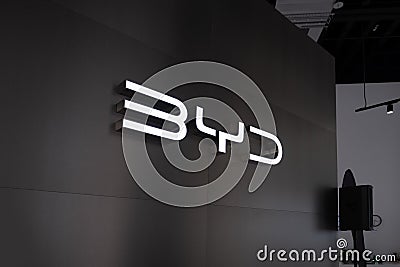 glowing Advertising banners BYD on black background, Chinese conglomerate manufacturer BYD Auto, corporation logo sign, company Editorial Stock Photo