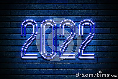 2022 glowing blue neon text on brick wall Stock Photo