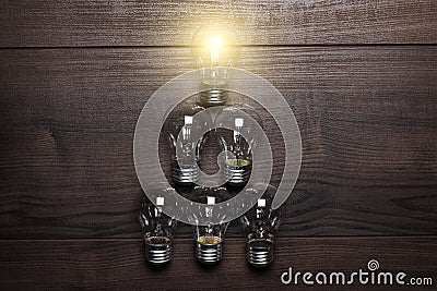 Glowing bulb leadership concept on wooden Stock Photo
