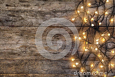 Glowing Christmas lights on wooden background Stock Photo