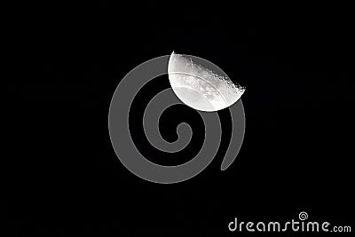 Glowing crescent moon illuminated in the inky-black night sky Stock Photo