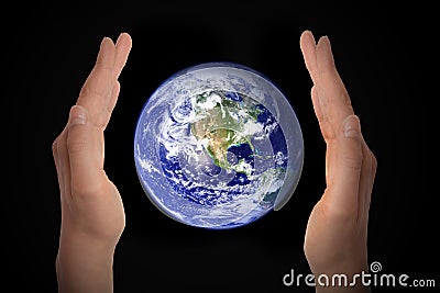 Glowing earth globe in hands on black, environment concept - elements of this image furnished by NASA Stock Photo