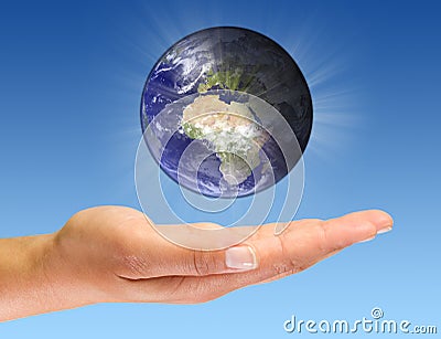 Glowing Earth on open palm Stock Photo