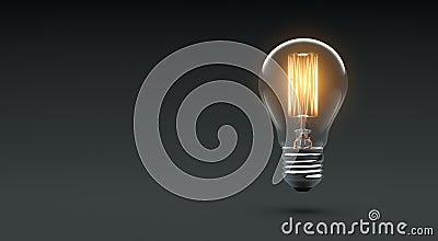 Glowing Edison light bulb on dark background Stock Photo