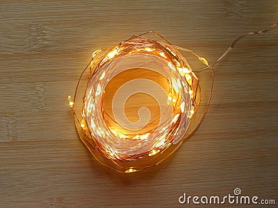 Glowing fairy lights on copper string Stock Photo