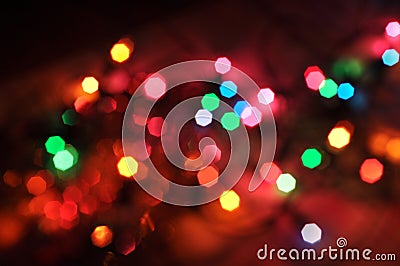 Glowing and festive colored light circles created from in camera and lens bokeh. Christmas fairy lights defocused giving a blurred Stock Photo