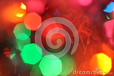 Glowing and festive colored light circles created from in camera and lens bokeh. Christmas fairy lights defocused giving a blurred Stock Photo