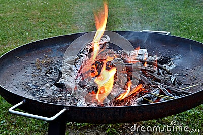 Glowing fire on disc grill Stock Photo