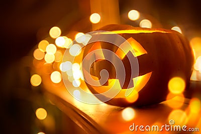 Glowing Halloween Pumpkin on Fireplace Stock Photo