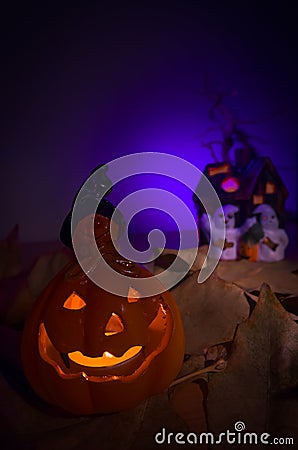 Glowing Halloween pumpkin and ghosts Stock Photo
