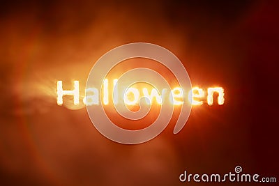 Glowing Halloween text burning red smoke Stock Photo