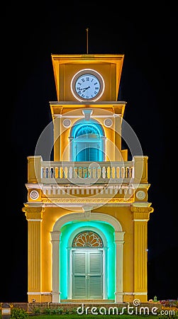 Glowing and illuminated Clock tower on a roundabout in old phuket town at night phuket thailand. Stock Photo