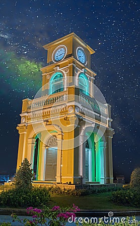 Glowing and illuminated Clock tower on a roundabout in old phuket town at night phuket thailand. Stock Photo