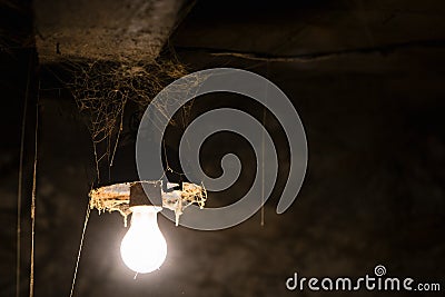 Glowing lamp in a barn Stock Photo