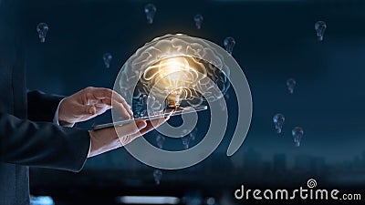 Glowing light bulb in brain over labtop of businessman Stock Photo