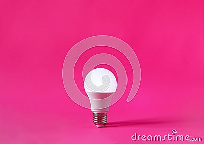 Glowing light bulb on magenta background. Discovery, invention, new idea concept Stock Photo