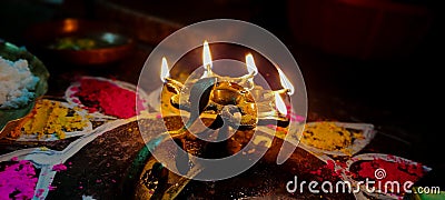 A glowing Multi Flame Lamp commonly known as Panchapradip. A holy thing used as an offering to God for worship. Surrounded by Stock Photo