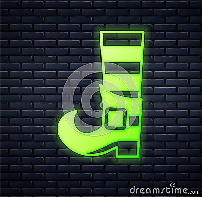 Glowing neon Leprechaun boot icon isolated on brick wall background. Happy Saint Patricks day. National Irish holiday Stock Photo