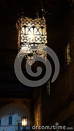 Glowing openwork forged metal street lamp Stock Photo