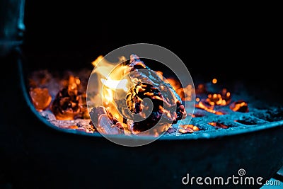 Glowing orange burning embers in a chiminea fire Stock Photo