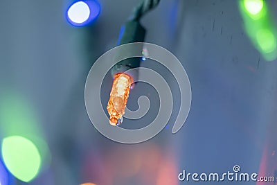 Glowing Orange Christmas Light Outdoors after Rain Stock Photo