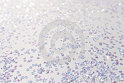 Glowing silver crystal confetti on a blue background. Stock Photo