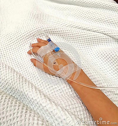 Glucose Drip tube inserted in right hand of sick patient Stock Photo