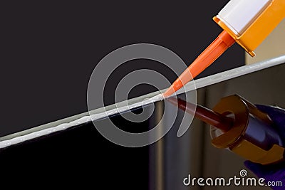 Glue gun, Applying silicone sealant by Caulking gun Stock Photo