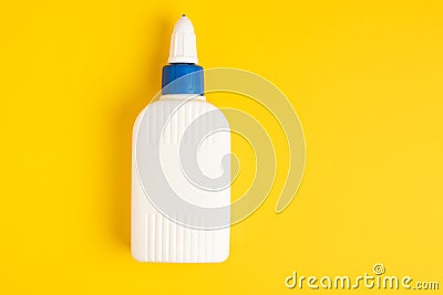 Glue plastic white bottle on a yellow background Stock Photo